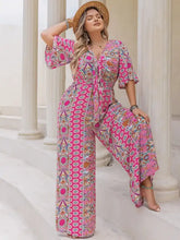 Plus size printed wide leg jumpsuit in vibrant pink with geometric floral pattern