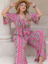 Plus size printed wide leg jumpsuit in vibrant pink paisley floral pattern