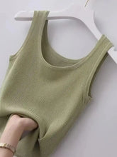 A soft olive green plus size ribbed knit scoop neck tank top hanging on a white hanger