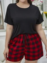 Plus size round neck tee shirt with short sleeve length paired with red and black plaid drawstring waist shorts lounge set