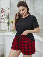 Plus size round neck tee shirt with sleeve length detail paired with red and black plaid shorts with drawstring waist lounge set
