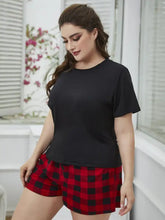 Plus size round neck tee shirt with sleeve length detail paired with black and red plaid shorts lounge set