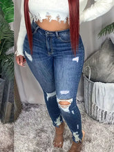 Plus size slim fit distressed jeans in blue denim with high waist and ripped details at knees and thighs