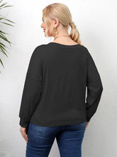 Plus size twisted drop shoulder black long-sleeve top with blue jeans