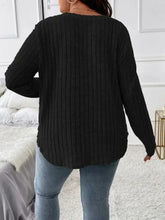 Plus size long sleeve V-neck black ribbed knit sweater with blue jeans