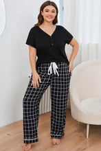 Plus size v-neck top with long sleeve length paired with black and white grid-patterned plaid pants lounge set