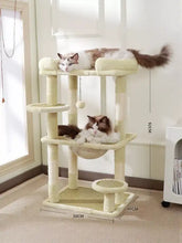 Plush cat tree condo with cream levels, sisal scratching posts, hammock perch
