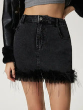Black denim mini skirt featuring a fuzzy black fringe hem for a stylish plush hem mini denim look