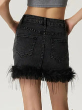 Black denim mini skirt featuring a plush feathered hem for a stylish mini denim look