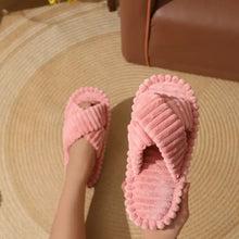 Pair of soft pink open toe flats slippers with criss-cross straps