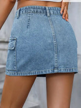 A light blue denim mini skirt with a cargo pocket and visible stitching details in a pocketed denim mini skirt style