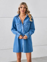 Blue denim mini dress with button front chest pockets and dropped shoulder design in casual denim fabric
