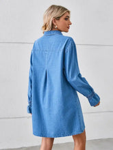 A light blue mini denim dress with dropped shoulder long sleeves and elastic cuffs in a pocketed design