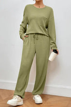 Olive green ribbed knit two-piece loungewear set with round neck top featuring long sleeve length and pants with pockets