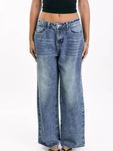 Wide leg jeans in faded medium-blue denim with classic stitching and button closure featuring functional pockets