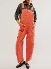 Pocketed wide strap denim overalls in loose orange utility style