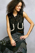 Black lace sleeveless cropped crochet vest with scalloped edge and white horseshoe pol button embellishments
