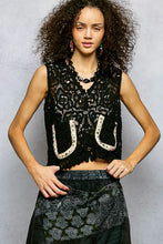 Black lace sleeveless scalloped edge cropped crochet vest with intricate floral patterns and pol button horseshoe appliqués