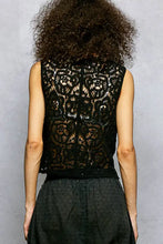 Black lace sleeveless pol button cropped crochet vest with intricate floral patterns and scalloped edge detail