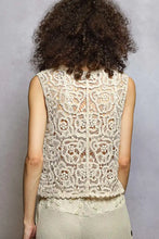 Beige pol button down cropped crochet vest with intricate floral lace patterns and scalloped edge hem