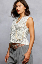White lace sleeveless pol button down cropped crochet vest with intricate floral patterns and a scalloped edge hem