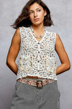 White lace sleeveless cropped crochet vest with pol button closures and scalloped edge decorative embellishments