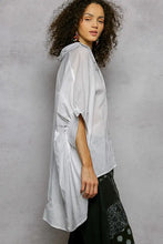 Light gray loose-fitting long-sleeved embroidered floral high low hem shirt with ruched sleeve detailing