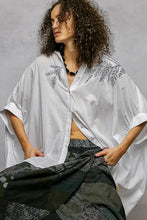White linen button down embroidered floral hem shirt with black leaf embroidery and high low hem design