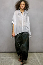 White sheer button-up shirt with black embroidered floral leaf patterns and a high low hem design