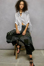 White embroidered floral button-up hem shirt with rolled sleeves and high low hem detail in lightweight fabric