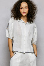 White linen embroidered floral short sleeve blouse with black embroidery on collar sleeves and hem