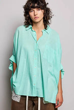 Pol button down half dolman sleeve shirt in loose-fitting mint green textured fabric with rolled sleeves