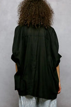 Black oversized blouse with puffed half dolman sleeves and relaxed fit in a dolman sleeve shirt style