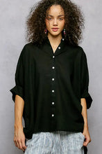 Black half dolman sleeve button down shirt with white buttons and rolled sleeves for casual wear