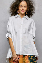 A light gray linen dolman sleeve shirt with a classic collar and rolled sleeves from the pol button down collection