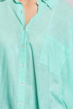 Light mint green linen pol button down shirt with subtle texture and matching pocket featuring half dolman sleeve