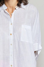 A lightweight white linen half dolman sleeve shirt with subtle texture and matching pocket pol button down