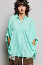Mint green loose-fitting pol button down shirt with half dolman sleeve and subtle textured weave for casual wear