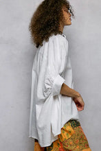 White linen blouse with gathered puffed sleeves and relaxed fit in a pol button down half dolman sleeve shirt style