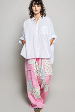 A white loose-fitting button-up half dolman sleeve shirt with rolled sleeves and chest pocket for casual wear