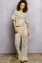Woman in POL crochet cardigan with sage green star motifs, relaxed fit