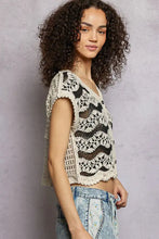 Cream-colored pol crochet button-down vest with scalloped edges featuring black lace patterns and button details