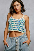 Teal and cream crochet cami with scalloped edge and thin straps featuring a patterned cropped design