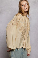 Beige long sleeve washed blouse with pol embroidery button and delicate floral patterns featuring bell sleeves