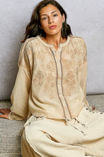 Beige long sleeve washed shirt with pol embroidery button closure and floral embroidered patterns on fabric