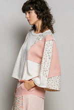 Patchwork textured slub knit round neck sweater with soft pink white and silver panels and floral sleeves