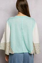 Mint green and cream patchwork textured slub knit blouse with round neck and floral bell sleeves by pol