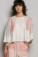 A cream and blush pink textured slub knit top with round neck and floral patchwork on sleeves and shoulders
