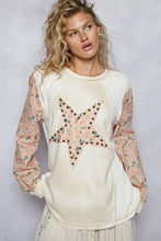 Cream-colored star patch thermal top with pink floral long sleeve and exposed shoulder seam detail