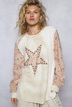 Cream-colored POL Exposed Seam star patch thermal top with floral sleeve length and pink star embellished with studs